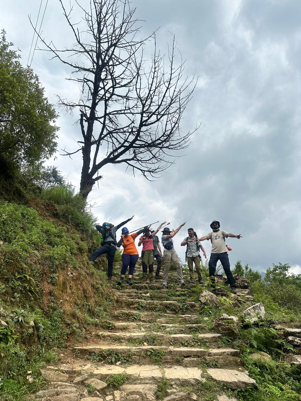 Trekkers hiking stone steps on Annapurna Base Camp trail Nepal