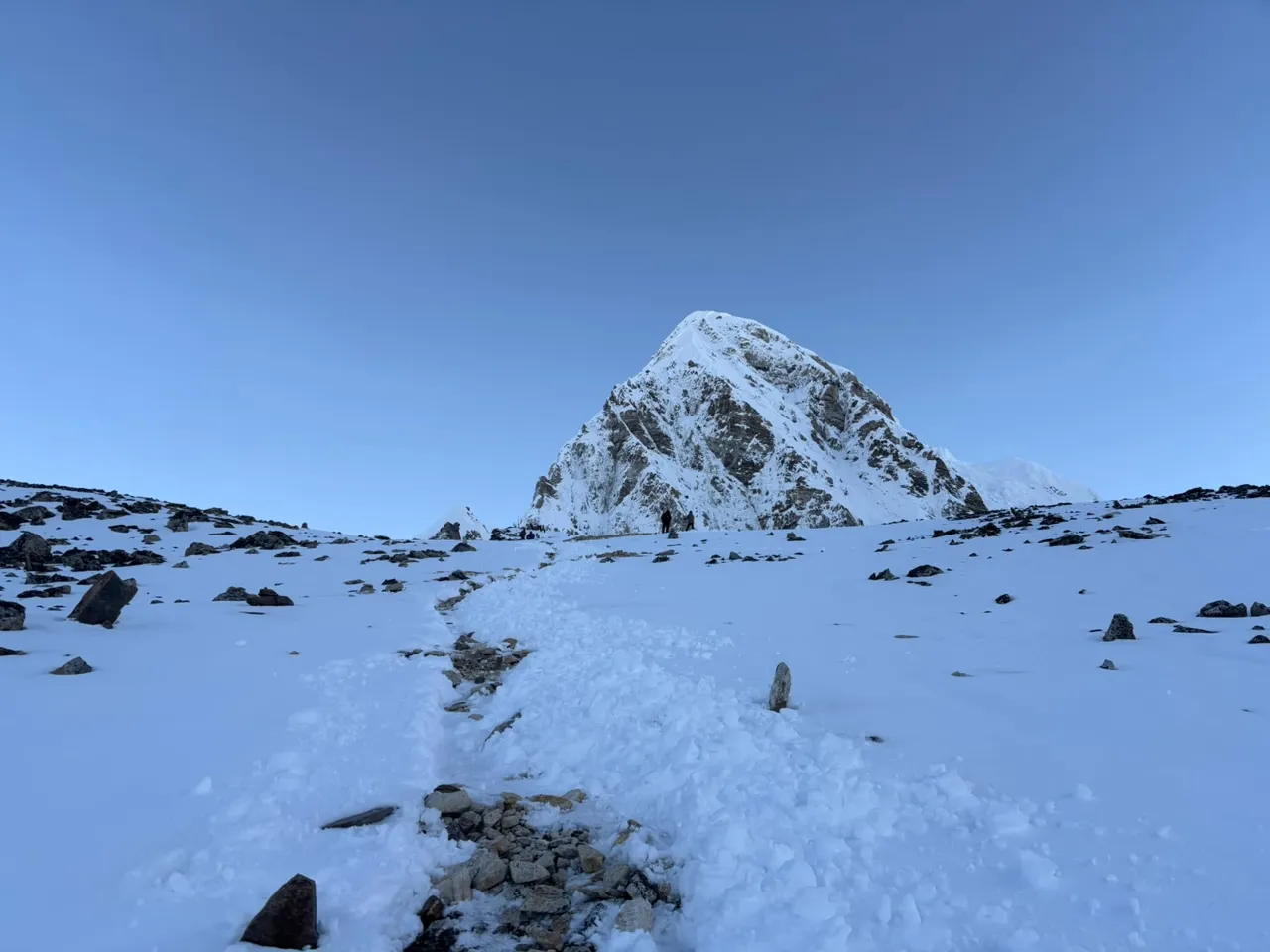 Snow-covered trail from Gorak Shep to Kala Patthar with Pumori ahead
