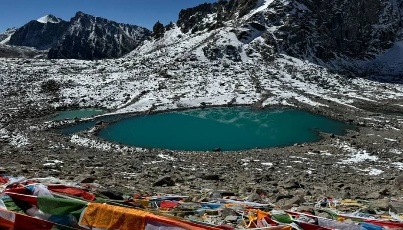 An image of Mansarovar lake blue lake surrounded by snow