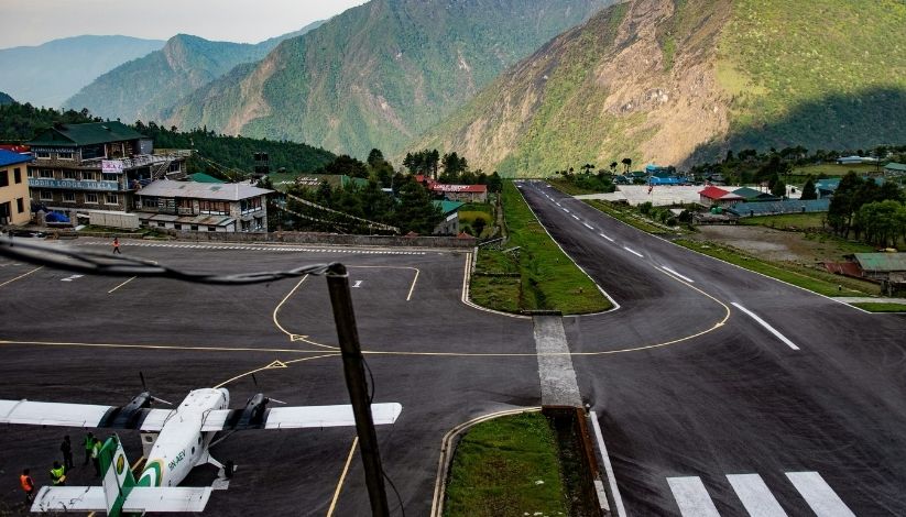 A image showing Lukla airport with an ariplan in the runway