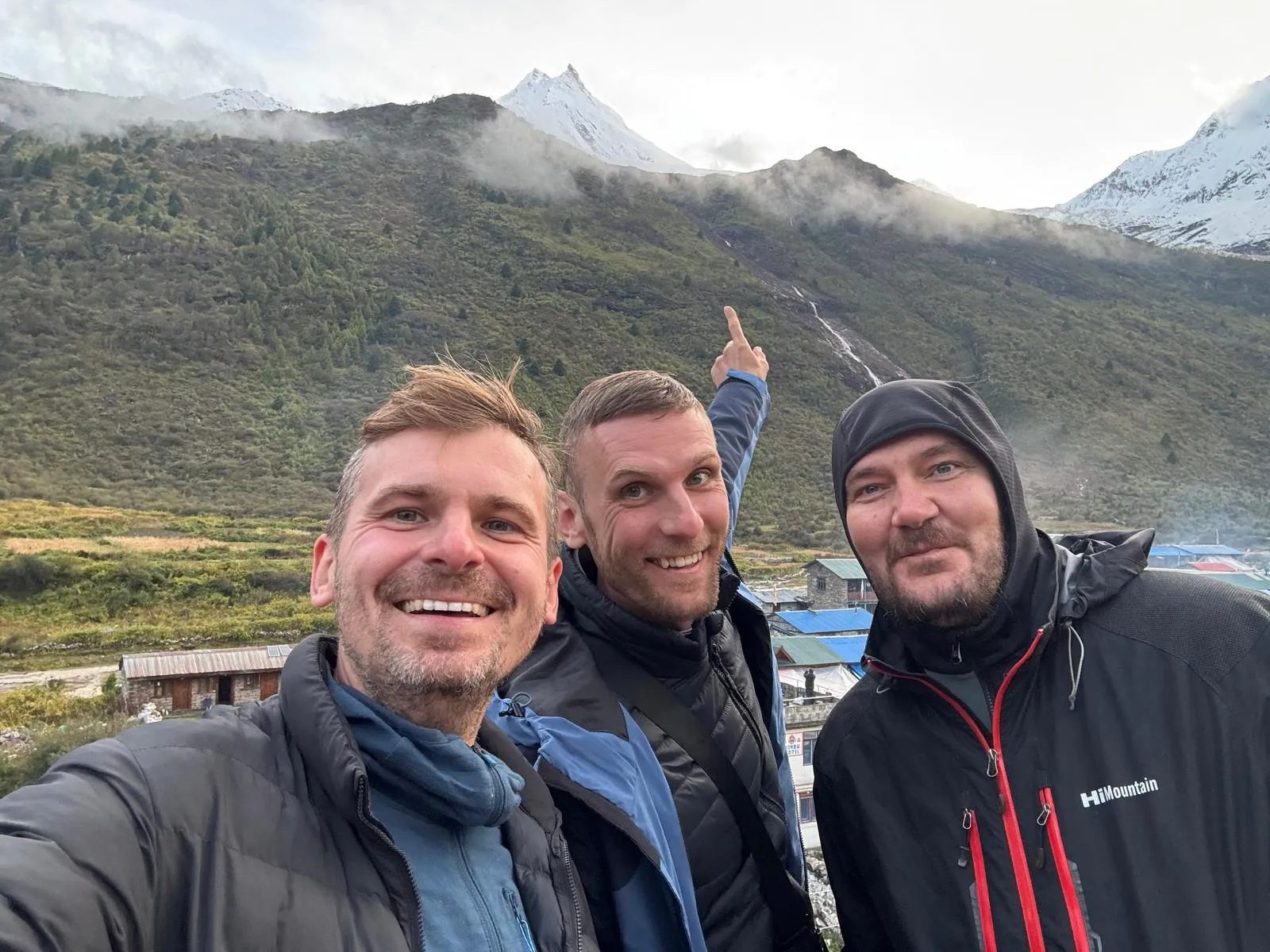 Trekkers in a quiet village on the Manaslu Circuit with Manaslu behind