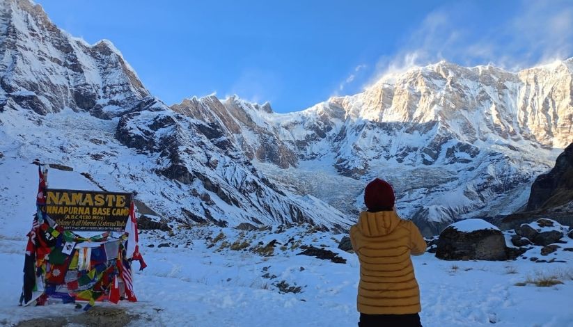 trekker enjoying the view at annapurna base camp after heli ride