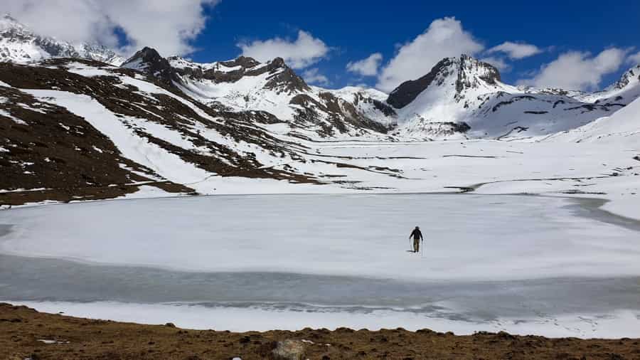 trekking enjoying frozen ice lake