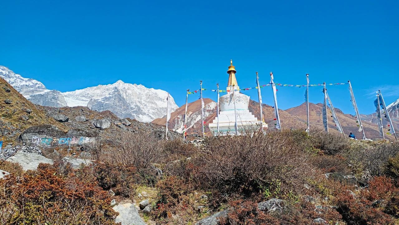 Buddhist stupa and prayer flags in the Langtang Valley with Himalayan peaks behind